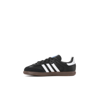 Kids’ black and white low-top sneakers with three stripes and gum outsole