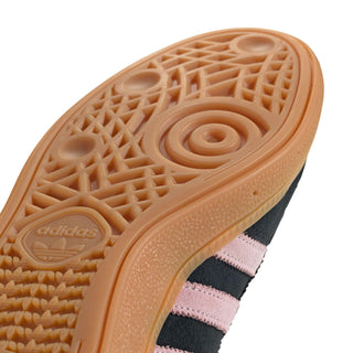 Close-up of women's sneaker outsole traction pattern on gum rubber