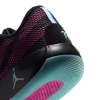 Men's basketball sneaker side detail, black upper with magenta accents and teal outsole