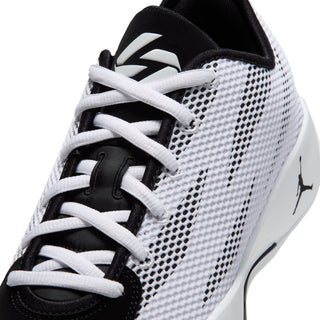 Close-up of white/black lace-up basketball shoe with mesh texture and swoosh-style stripe