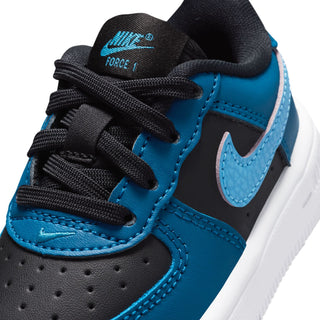 Kids' sneaker close-up with black laces, blue leather panels, and Nike logo.
