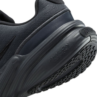 Youth black Nike sneaker side close-up of cushioned midsole and molded heel logo.