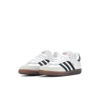 Kids pair of white sneakers with black three-stripe bands and gum soles