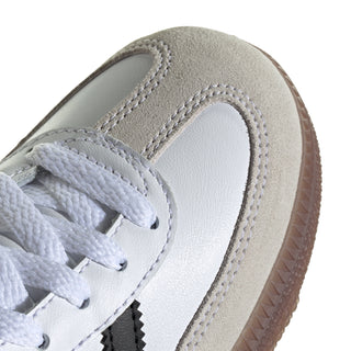 Kids white leather sneaker close-up with light laces and black side stripe