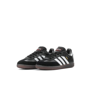 Kids black sneakers with white adidas stripes and gum sole, front view pair