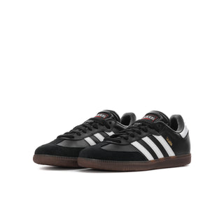Pair of black youth Samba sneakers with white stripes and brown gum outsoles