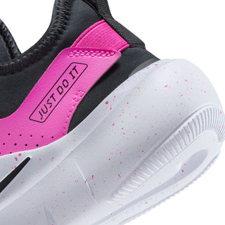 Youth running shoe close-up, fuchsia tongue tab with 'JUST DO IT' and white foam.