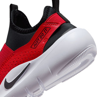 Kids running sneaker close-up, red-and-black upper with Nike Swoosh on white sole