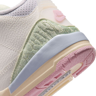 Close-up kids' sneaker side: mint green textured panel with pink accent on midsole