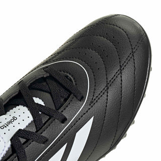 Kids black leather-look soccer cleats with white laces and side stitching