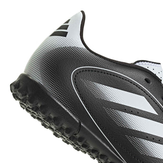 Kids black-and-white soccer cleat side with molded studs and ventilation holes