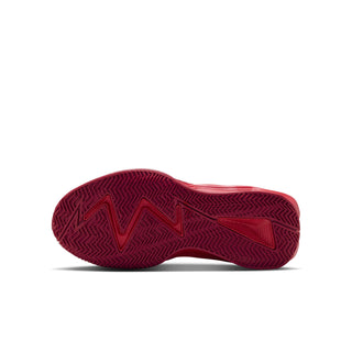 Youth basketball shoe outsole with dark patterned tread on red rubber