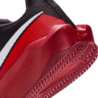 Youth basketball shoe close-up, red textured midsole with black upper and white swoosh