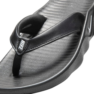 Women’s black thong sandal close-up of strap detail and textured footbed