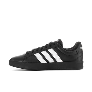 Side view of women's black sneakers with white stripes and black rubber sole
