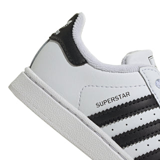 Toddler sneaker side close-up with 'SUPERSTAR' logo and black stripe accent