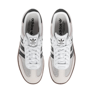 White and silver glitter sneakers with lace-up front and adidas logo on tongue