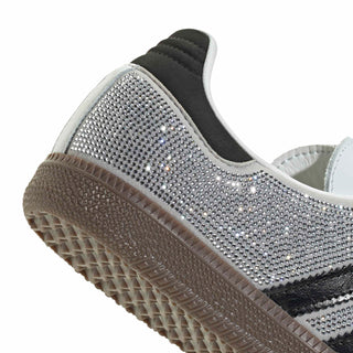 Close-up of heel and side: rhinestone upper, dark collar, and gum sole tread