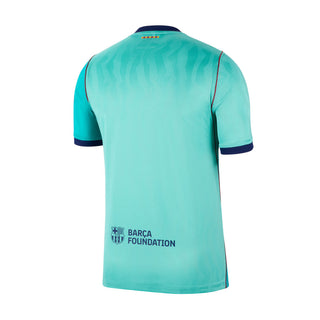 Teal soccer jersey back with Barca Foundation text and navy-trim collar