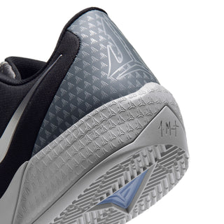 Men's sneaker side with gray patterned panel, white midsole, and tread outsole