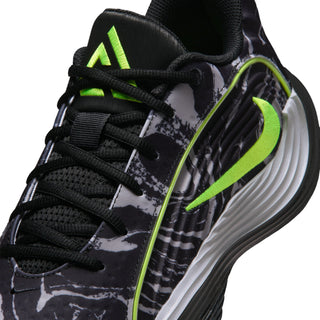Close-up of black mens shoe upper with laces, camo print, and volt green accents