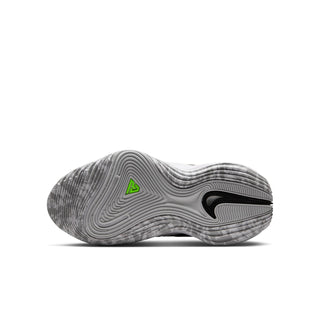 Youth basketball shoe outsole view, ribbed traction with neon green heel emblem