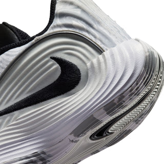 Kids sneaker close-up of side: silver-gray wavy texture with black Nike swoosh and trim