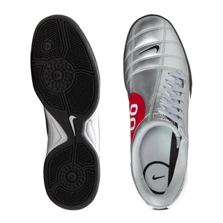 Silver women’s sneaker outsole and side profile with black traction pattern and lace-up