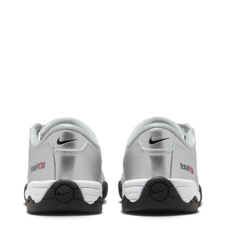 Silver women’s lace-up sneaker heel view with Nike logo and black traction wedge