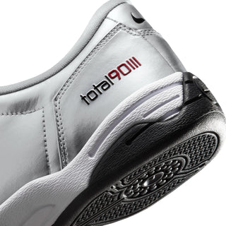 Metallic silver women’s sneaker side detail with red triple-III logo and black rubber sole