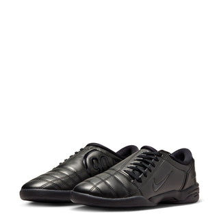 Women's T90 black sneakers, side view with Nike swoosh and lace-up front.