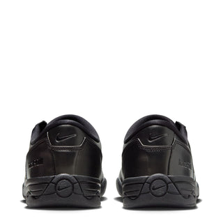Women's T90 black sneaker back view with Nike swoosh and lace-up collar padding.