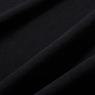 Black fleece fabric close-up with soft knit texture