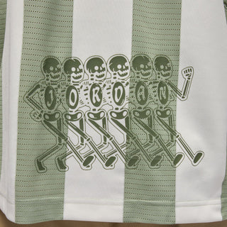Men's goalie top fabric close-up: green goalkeeper graphic across white stripe panel