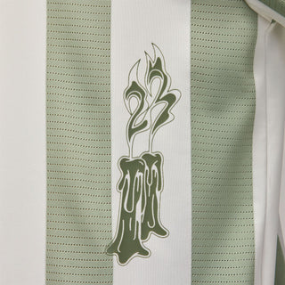 Men's goalie top close-up: green flame-style crest print on white stripe panel