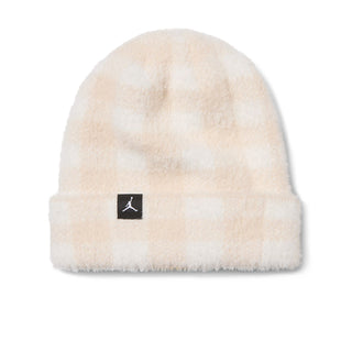 Cream plush beanie with folded cuff and black logo patch