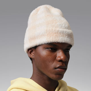 Cream plush beanie with folded cuff, front three-quarter view