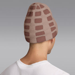 Fuzzy beanie with brown-and-cream geometric blocks, black logo patch, back/side view