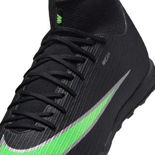 Close-up of men's black turf football boot upper with green swoosh and laces