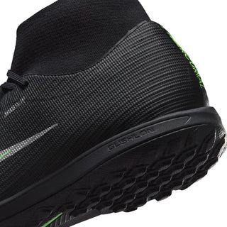 Close-up of men's black turf boot sidewall and sole edge with green details