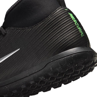 Youth cleat side close-up: black knit upper with neon green heel text