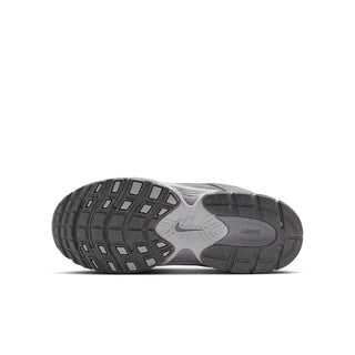 Outsole view of youth dark gray sneakers with grippy tread and heel support