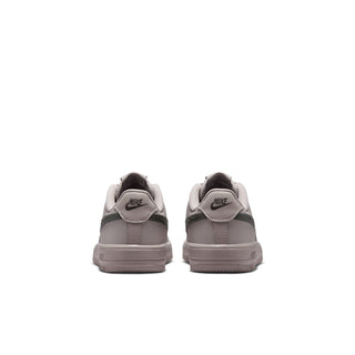 Kids low-top sneakers in light grey with rear Nike logo and lace-up closure