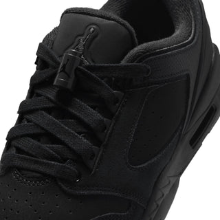 Close-up of black youth sneaker upper with lace eyelets and padded tongue