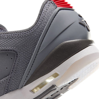 Close-up of youth sneaker side panel with gold air window and red heel details