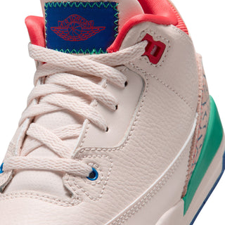 Kids retro sneaker closeup, off-white lace upper with red tongue and JORDAN patch