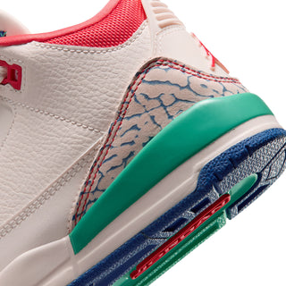 Kids retro sneaker closeup, off-white leather with stitched blue pattern and green midsole