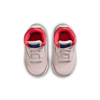 Toddler sneaker pair top view: cream uppers with red inner lining and lace closure
