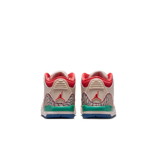 Toddler sneaker back view with red heel tabs, embossed wing logo, and teal midsole