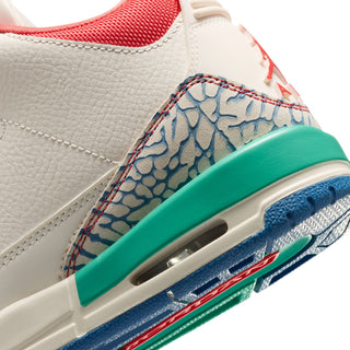 Youth sneaker close-up of side panel and midsole with blue pattern, teal trim, and Air unit